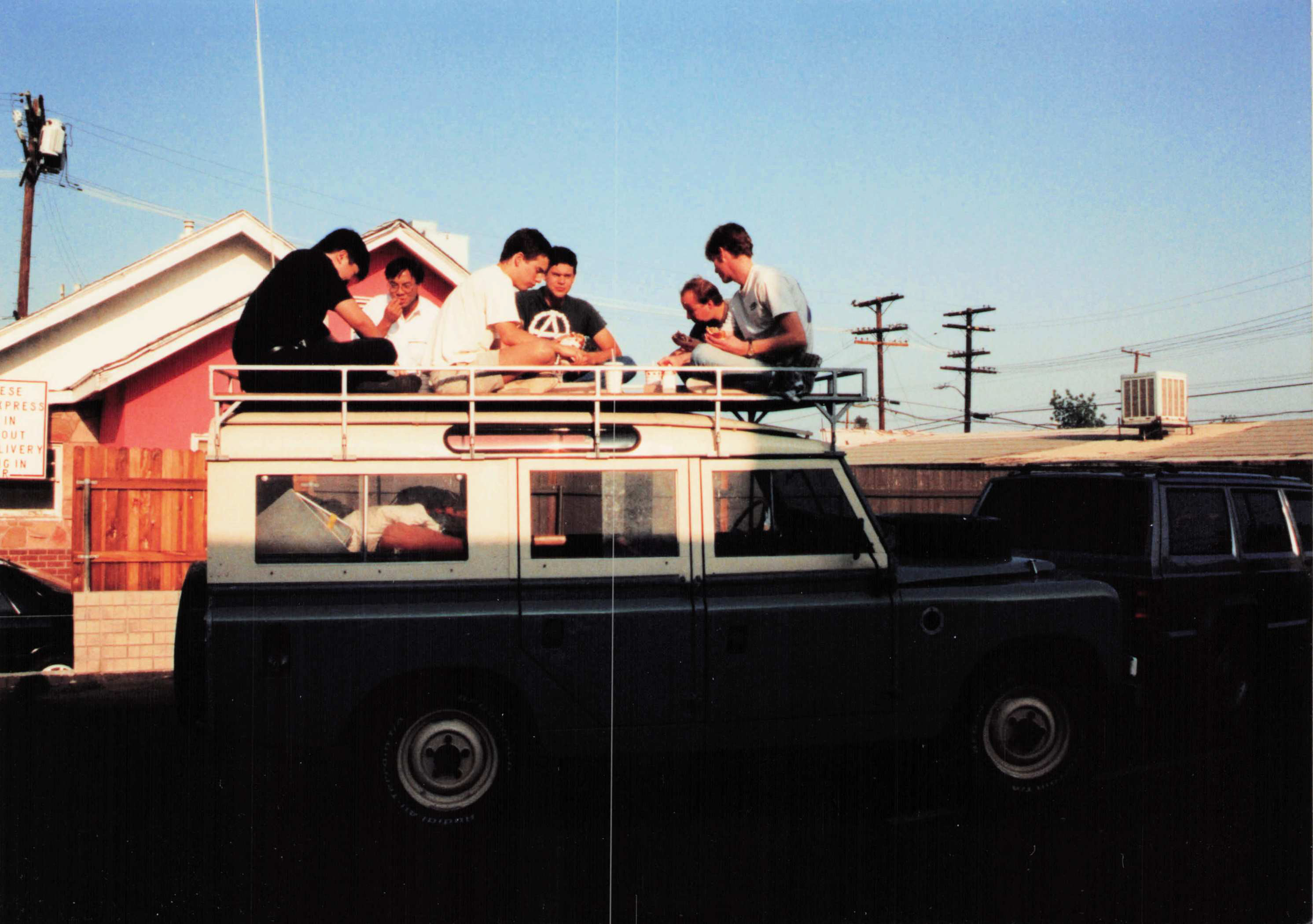 Six people on the 109 Station Wagon roof rack, after Gorilla Ball