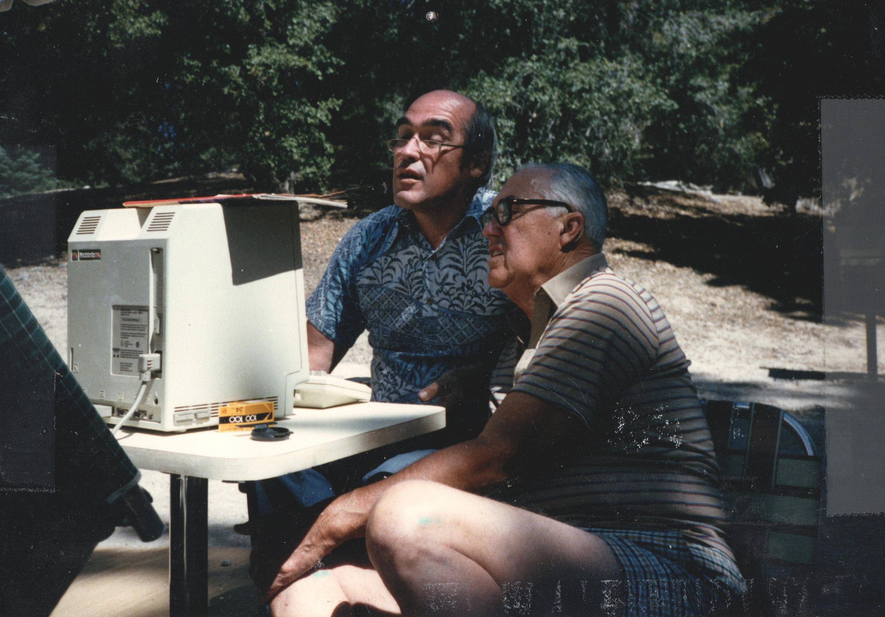 Phil and Gramp with the Mac, outdoors at camp