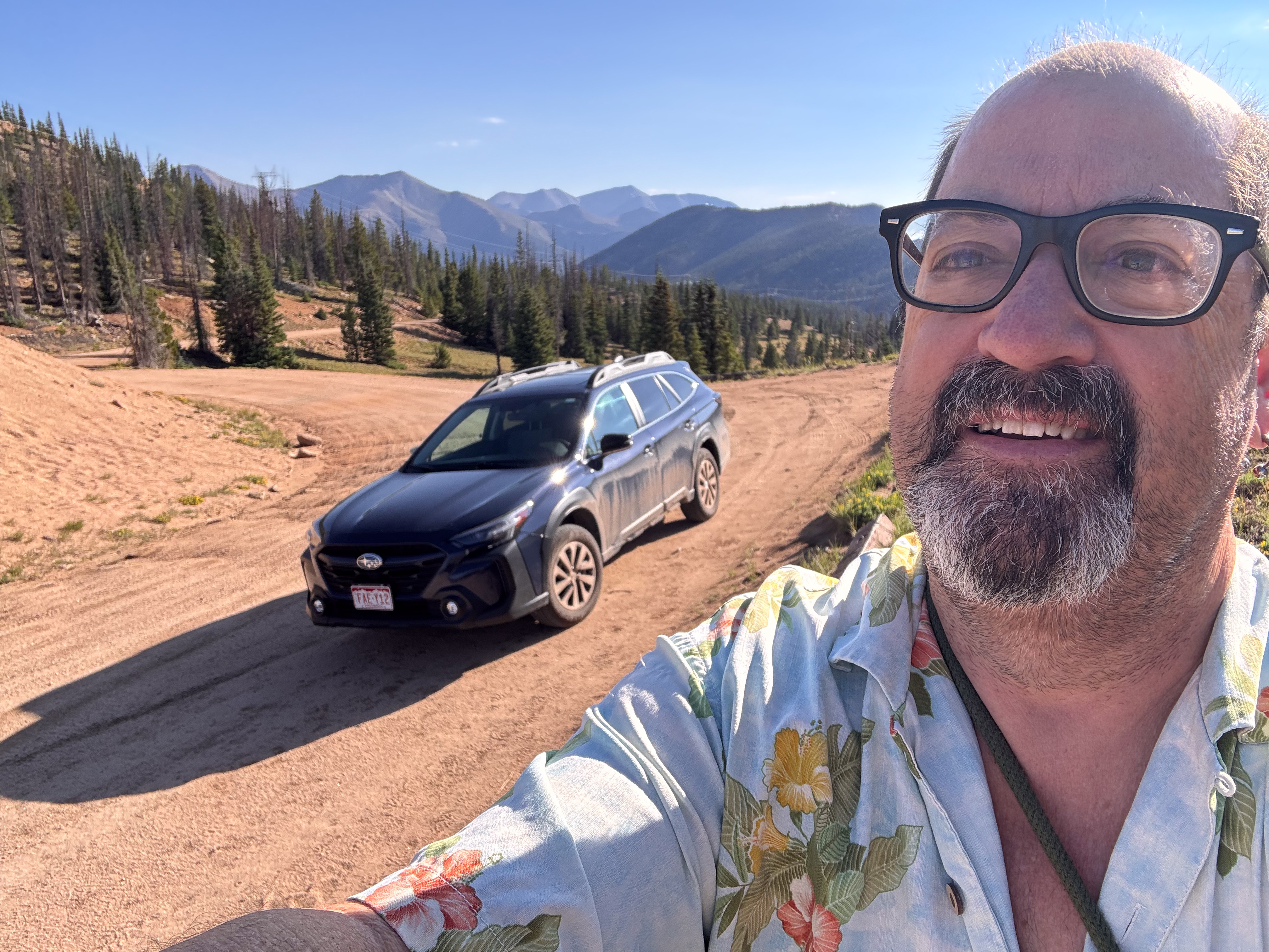 The rental Subaru at Old Monarch Pass, pines and peaks behind.