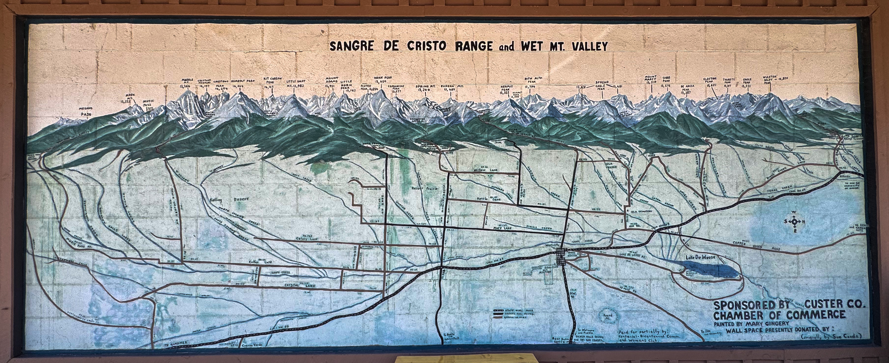 A painted mural map of the Sangre de Cristo Range and Wet Mountain Valley, peaks labeled by name and elevation.