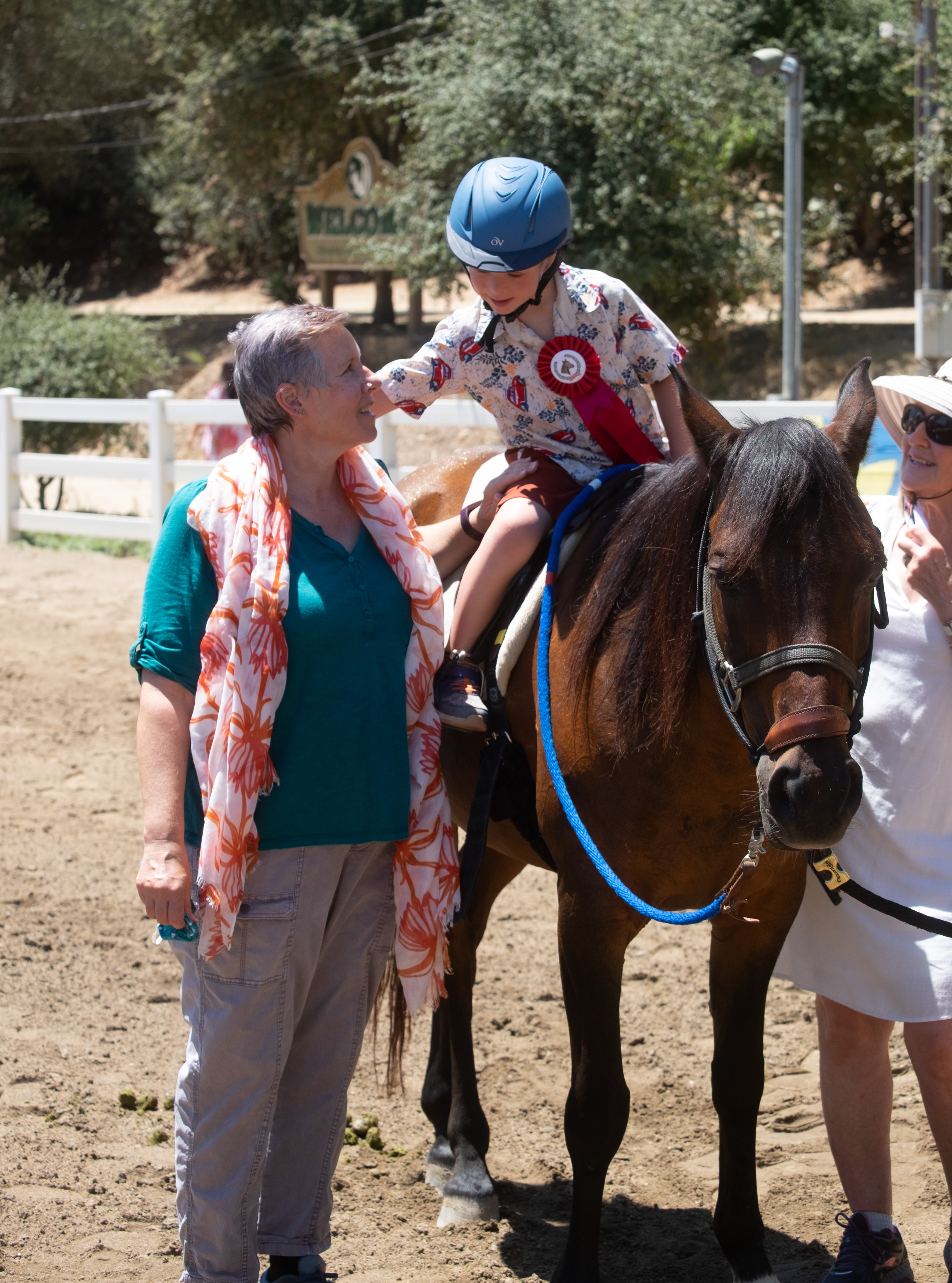 Dylan at REINS therapeutic horsemanship with Grandma Elise, 2020