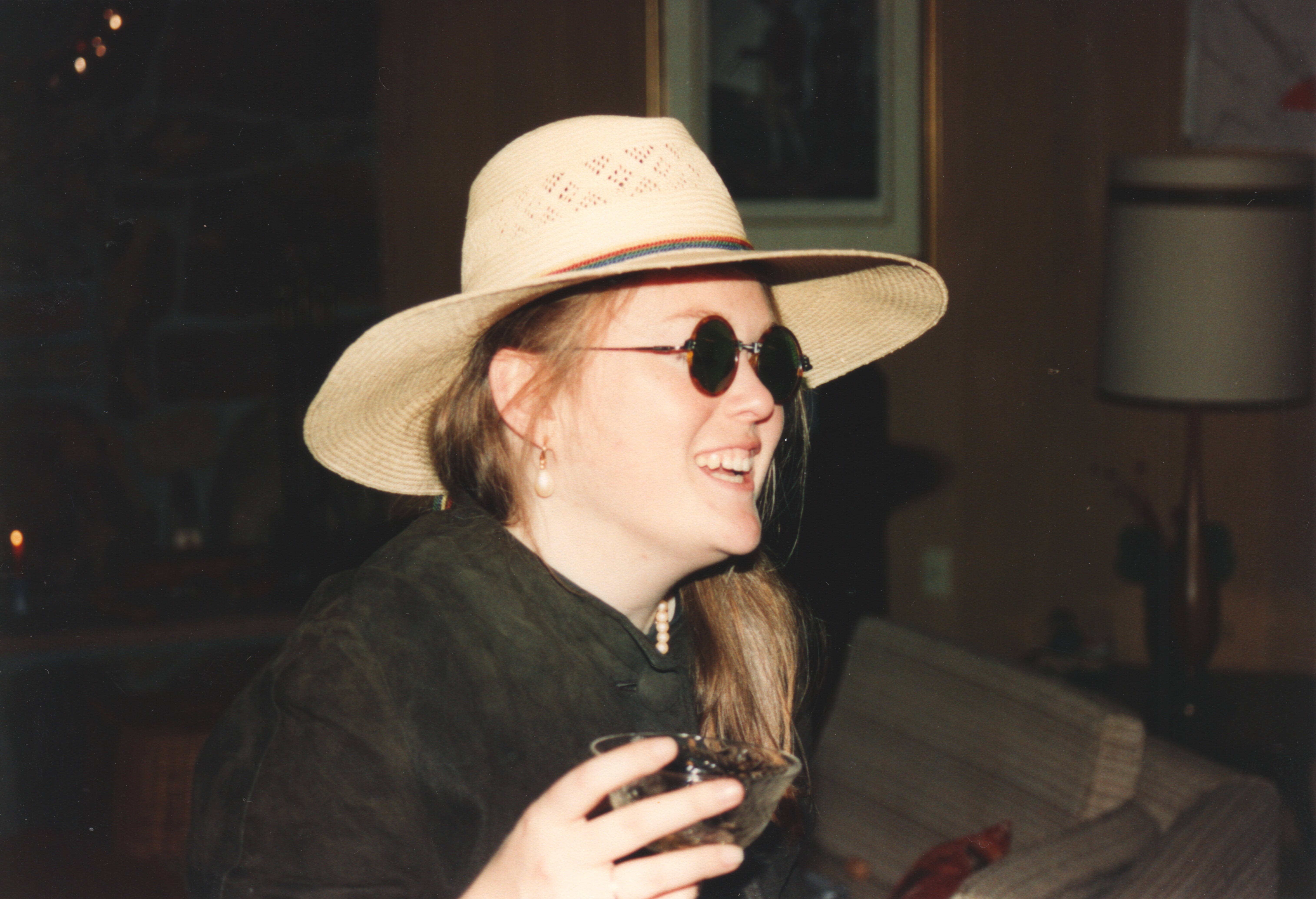 Rebecca Casey in the wide-brimmed straw hat (an NYE party prop), laughing