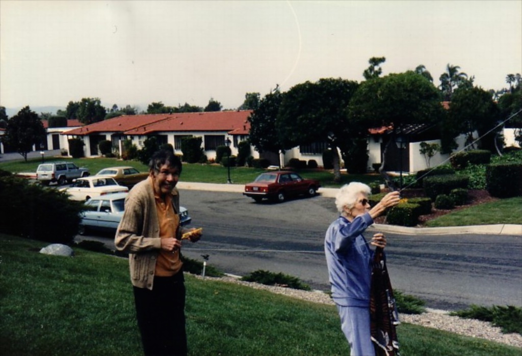 An adult man (believed to be Elmer Jr.) with his elderly mother [[helene-rickard-heald|Gagalene]] on a retirement-community lawn, est. 1980s — identification uncertain; the only candidate adult photo found