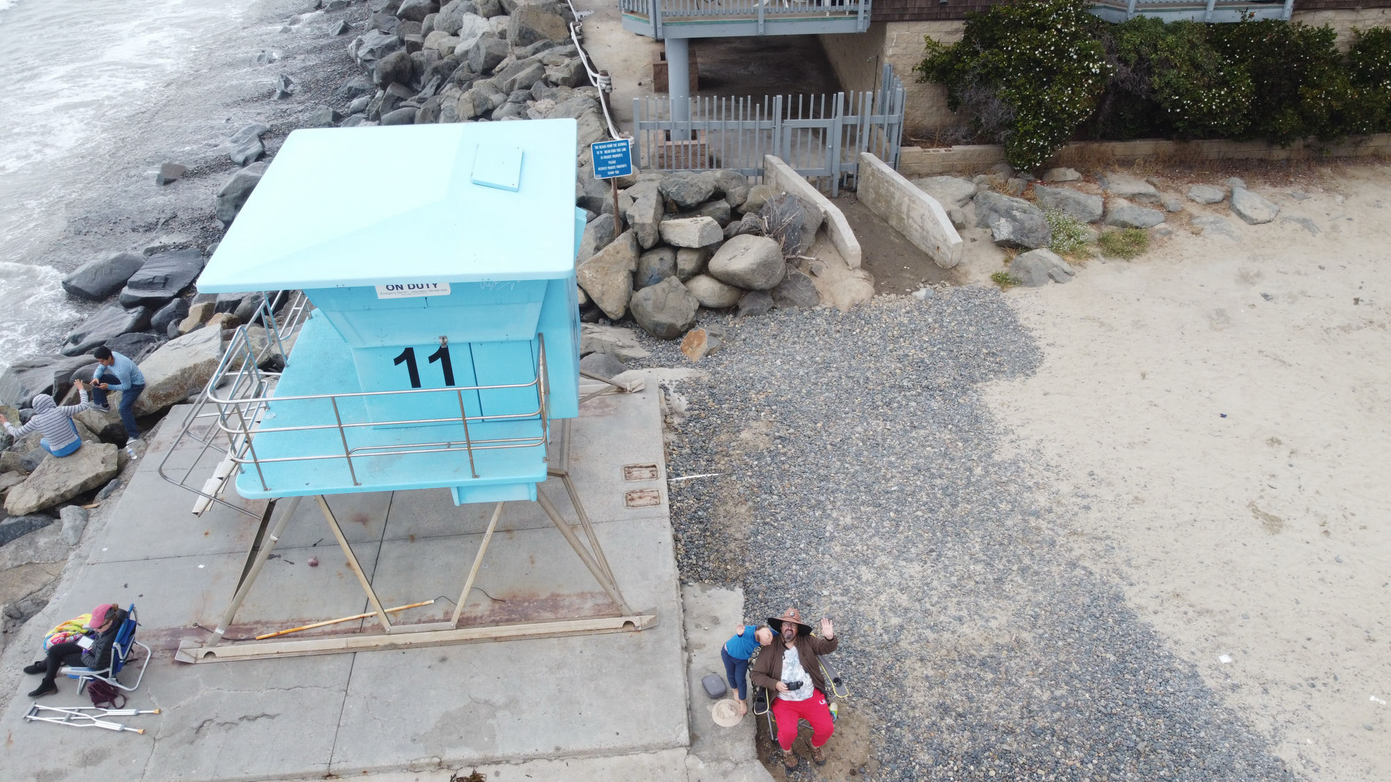 Waving up at the drone.