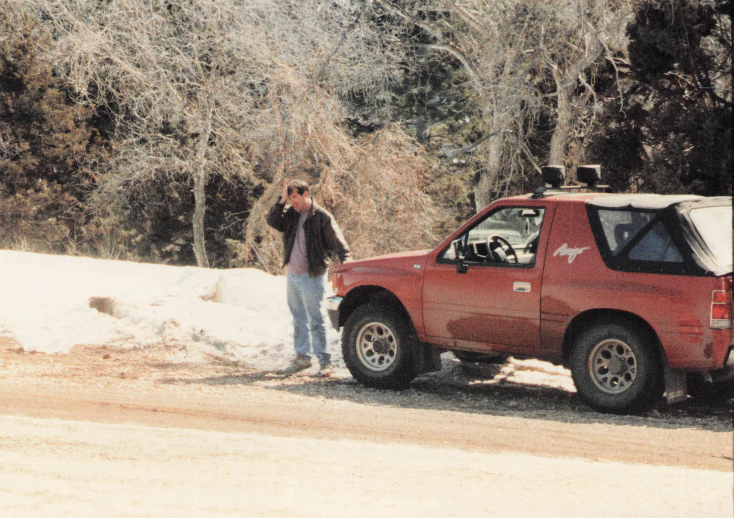 Fred beside the Amigo in snow, cottonwood trees behind
