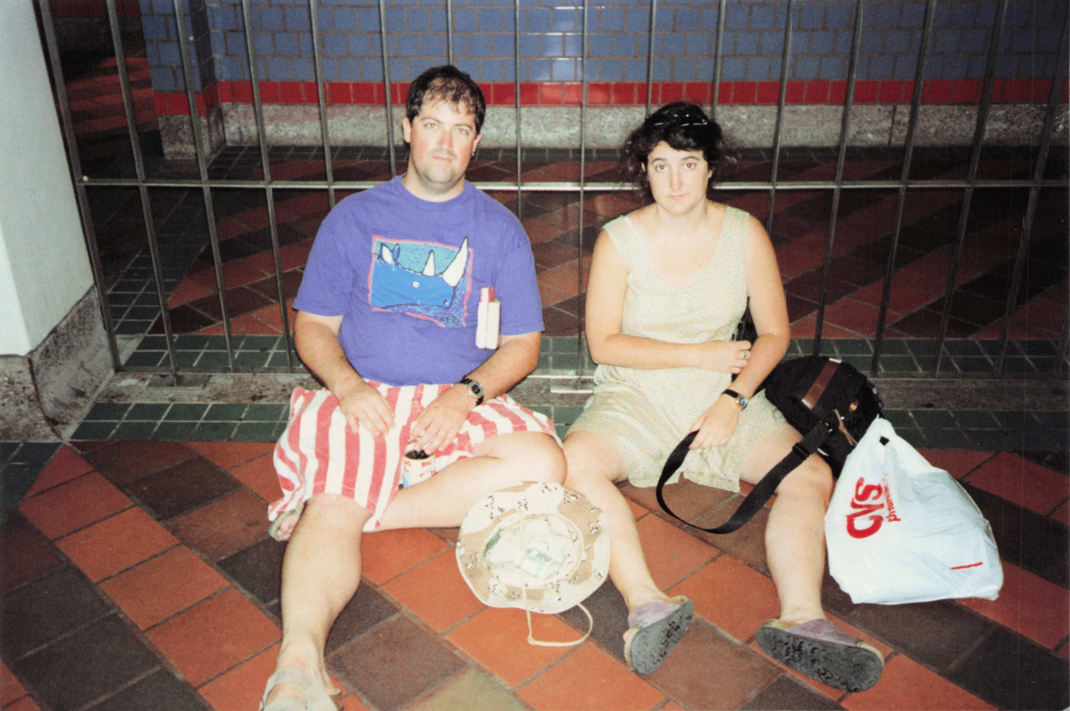 Fred and Misty on the floor of MIT station, CVS bag, pretending to panhandle