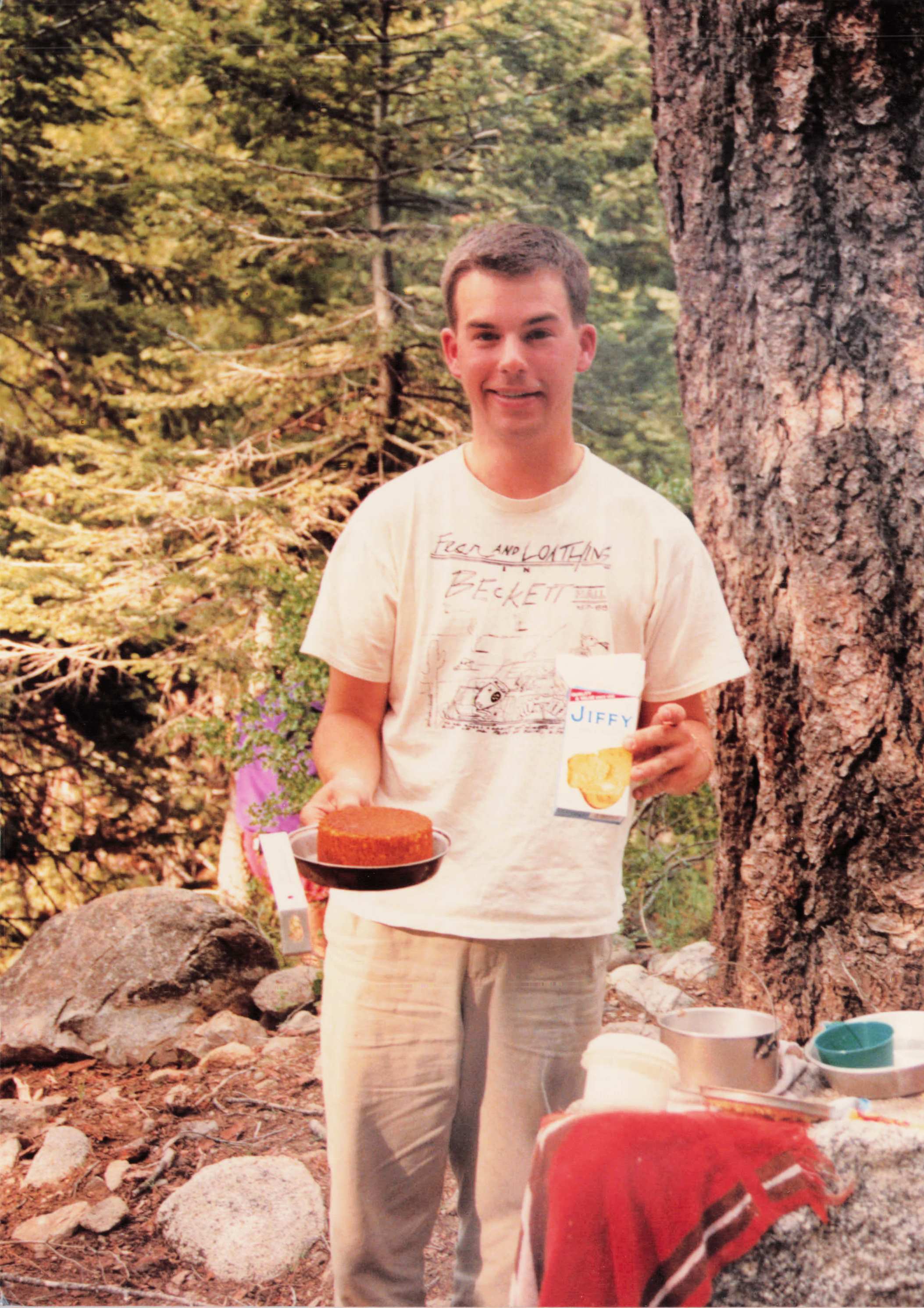 Chris Hubbard at a Sierra camp, holding a fresh-baked cake