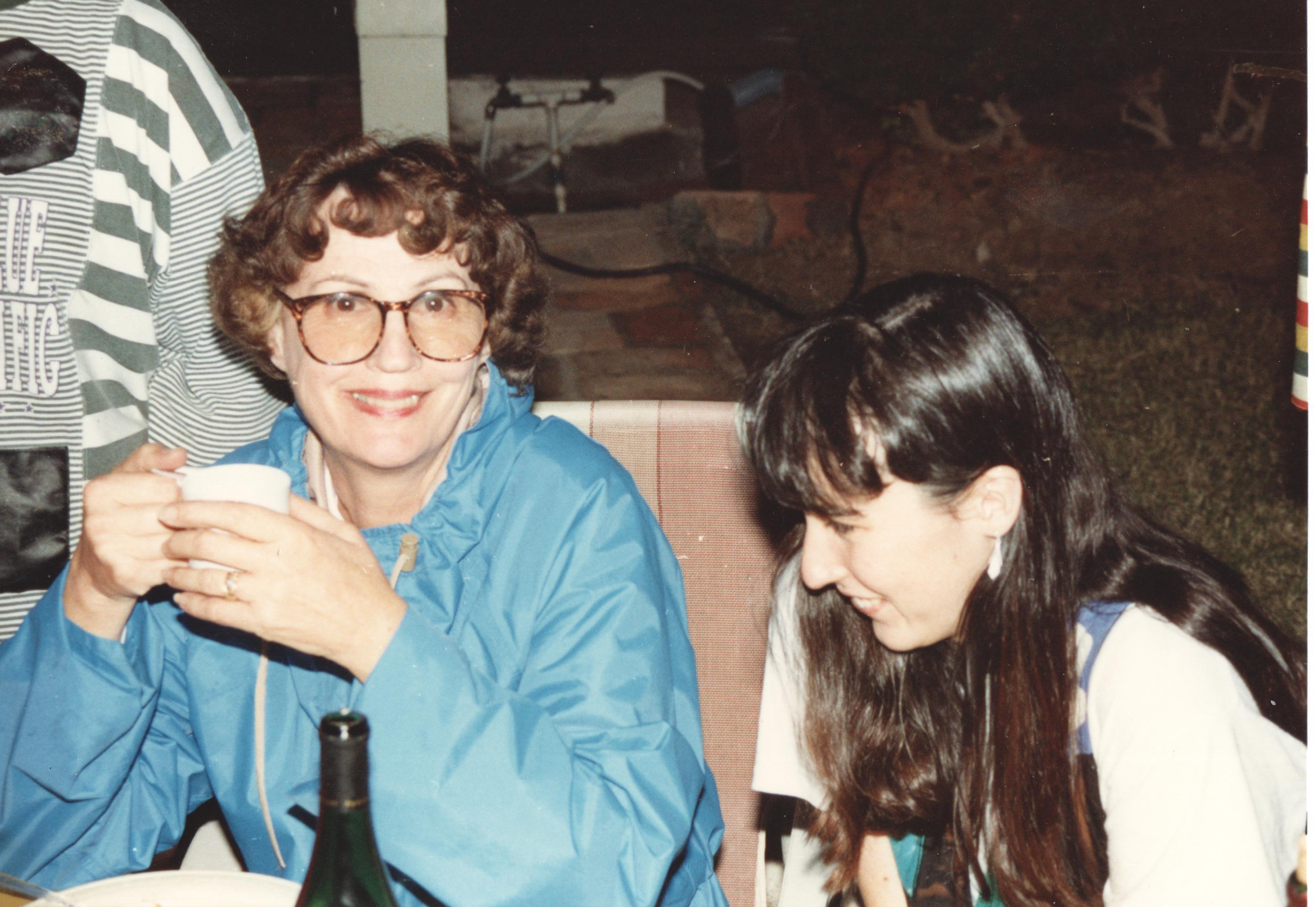 Carol at an outdoor family dinner, mid-to-late 1980s, coffee in hand