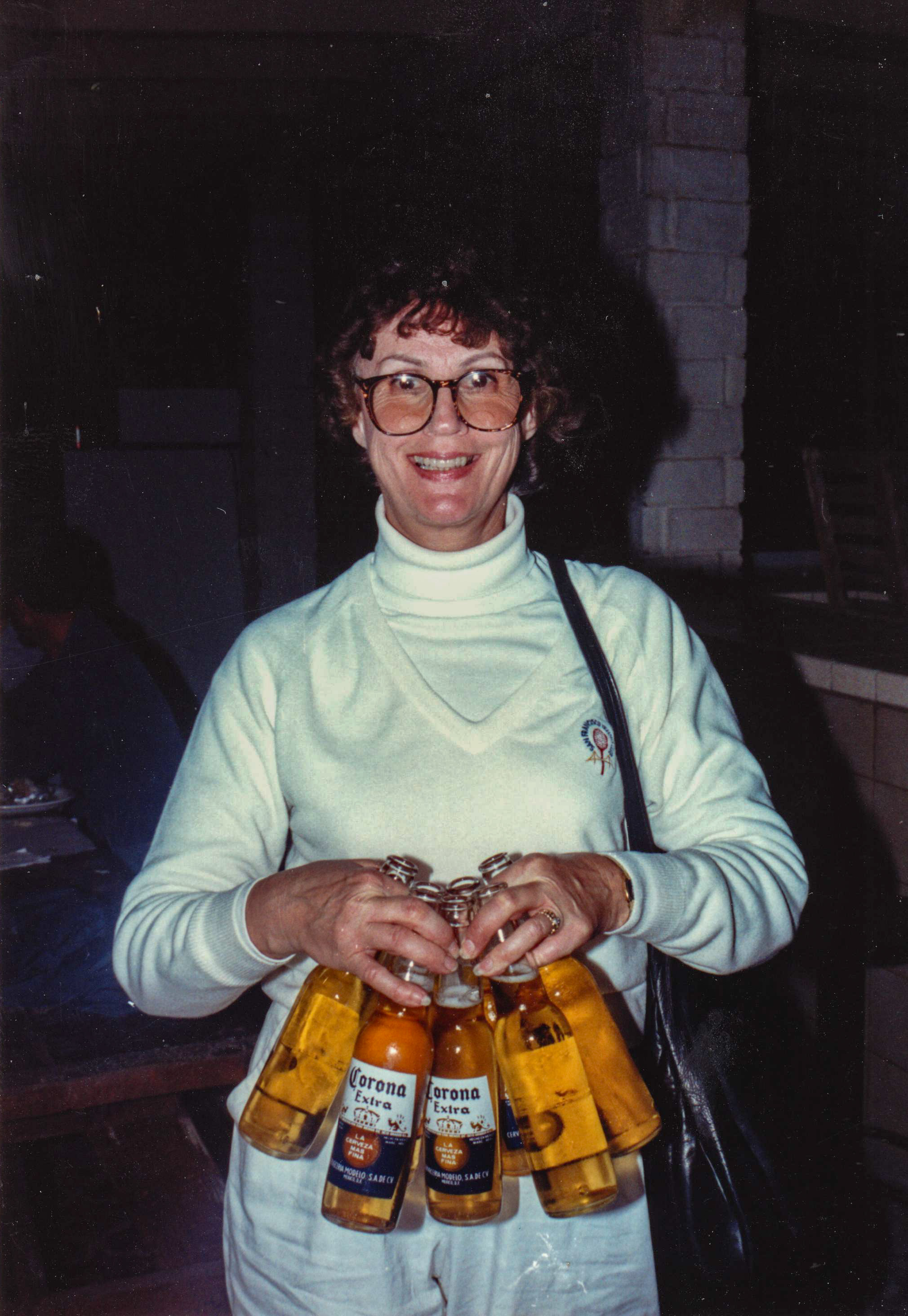 Aunt Carol, mid-to-late 1980s — Alan's wife, a former flight attendant — grinning behind a six-pack of Corona