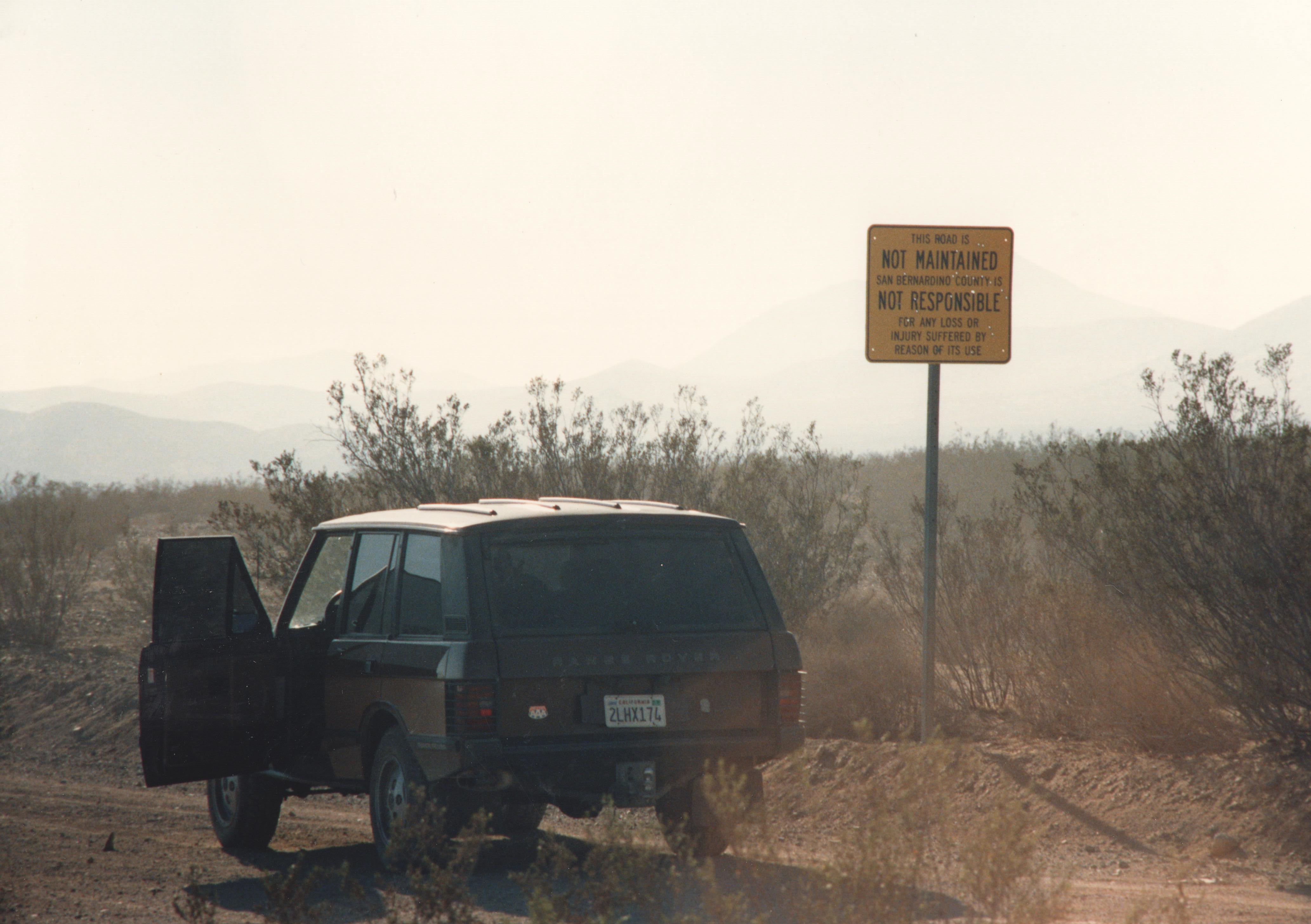 Range Rover (CA plate 2LHX174) driving an alkali desert road