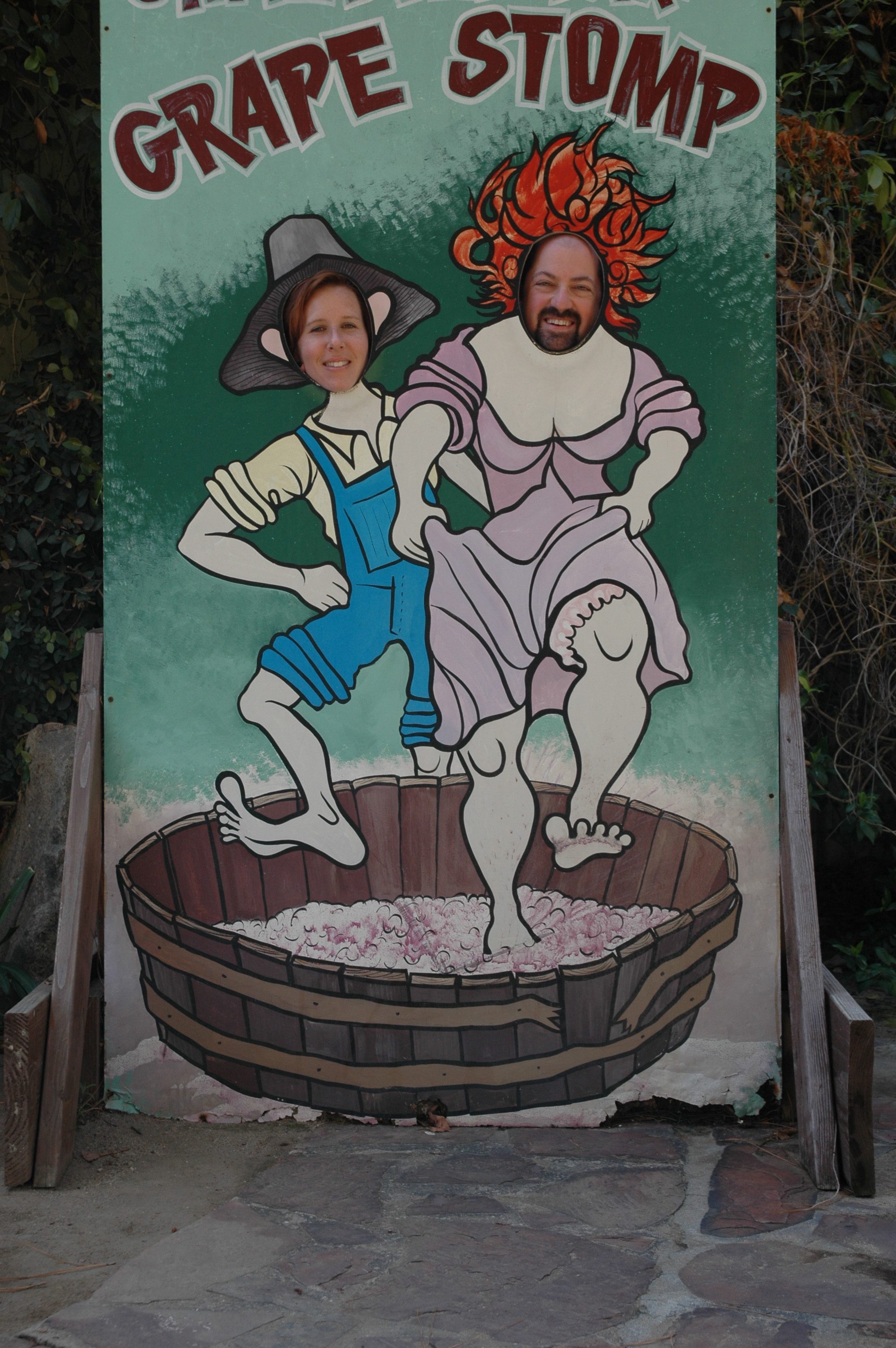 Fred and Becke at the Orfila Winery grape-stomp cutout — Fred's face on the woman