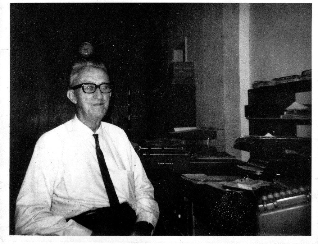 H.P. at his desk amid the typewriters and ledgers of the Imperial Hardware office, El Centro. Est. 1960s.