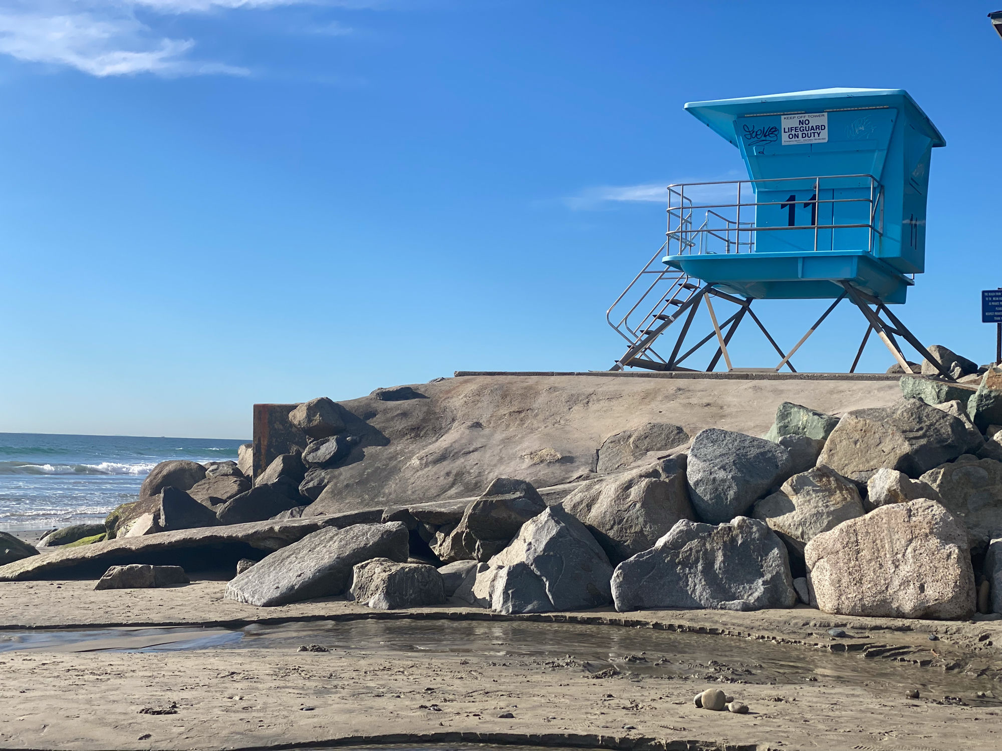 Graffiti tag and a private-beach sign — no shortage of either here.
